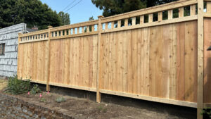 A wooden privacy fence with a decorative lattice top installed by Helmco Fences in Seattle, WA.