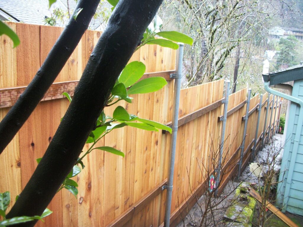 A wooden privacy fence with sturdy metal posts installed by Fix-A-Fence LLC in Portland, OR.