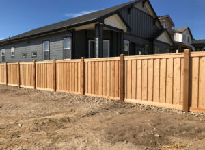 A wooden privacy fence surrounding a new home, built by Colorado Springs Fence Company in Colorado Springs, CO.