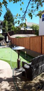 A wooden privacy fence installed next to a putting green by Sacramento Valley Fencing in Sacramento, CA.