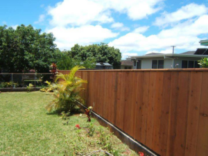 A newly installed wooden privacy fence in a residential backyard by Allied Security Fence in Kapolei, HI