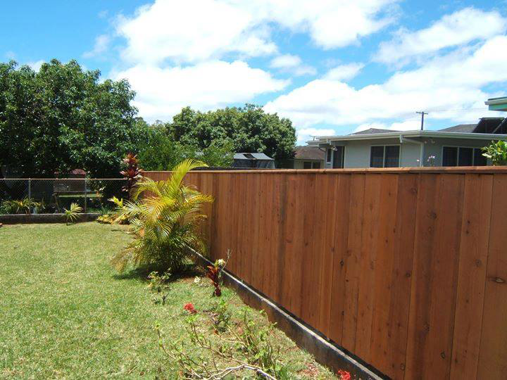 A newly installed wooden privacy fence in a residential backyard by Allied Security Fence in Kapolei, HI
