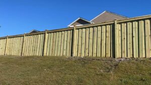 A tall wooden privacy fence installed for a residential property by JB Nealy Fence in Elgin, SC.