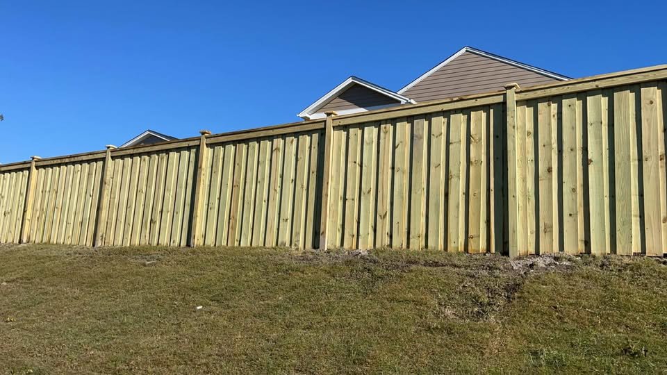 A tall wooden privacy fence installed for a residential property by JB Nealy Fence in Elgin, SC.