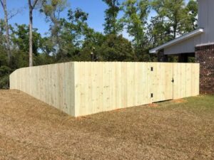 A newly installed wooden privacy fence around a residential property by Kelley Fence and Gate in Eva, AL.