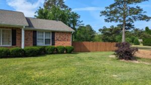 A wooden privacy fence installed around a residential yard by JB Nealy Fence in Elgin, SC.
