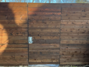 A custom wooden privacy fence with a solid gate installed by B & S Fence Company in Haltom City, TX