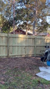 A wooden privacy fence under construction in a residential area by Julien Affordable Fencing LLC in Jacksonville, FL