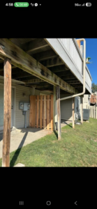 A wooden privacy fence section installed under a deck by Schulze Enterprises in Bellevue, NE.