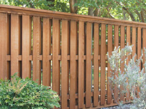 A modern wooden privacy fence with vertical slats, expertly installed by Superior Fence & Rail of Arkansas in Springdale, AR.