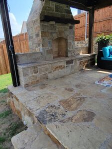 A well-maintained wooden privacy fence bordering a lush backyard garden by Ft Worth Fence And Patio in Fort Worth, TX.