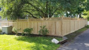 A long wooden privacy fence with a decorative lattice top, installed by H&M Fence, LLC in Norwalk, CT.