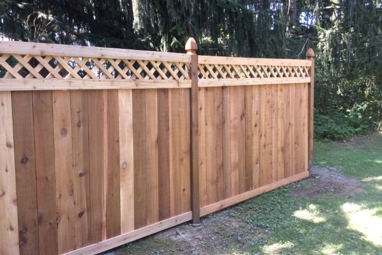 A wooden privacy fence with a decorative lattice top, installed by Fence Company of Rhode Island in Providence, RI.