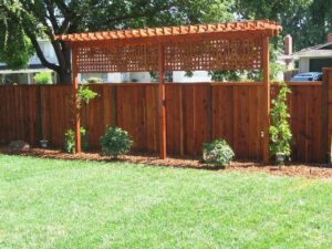 A custom wooden privacy fence with an integrated trellis installed by Austintown Fence in Youngstown, OH.