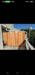 A wooden privacy screen installed on a deck by Schulze Enterprises in Bellevue, NE.