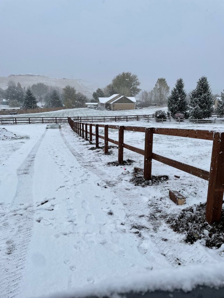 A newly installed wooden rail fence in a snowy landscape by Integrity Gates and Fencing in Yakima, WA