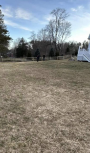 A long wooden split-rail fence installed across a large property by Hunter & Sons Fence in Arlington, MA.