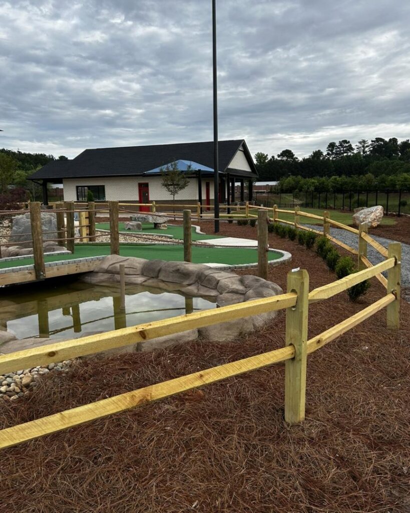 A wooden split-rail fence surrounding a miniature golf course installed by Georgia Select Fence in Senoia, GA.