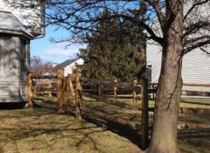 A wooden split-rail fence with wire mesh installed around a residential property by Crompton Fence Company in Charleston, SC.