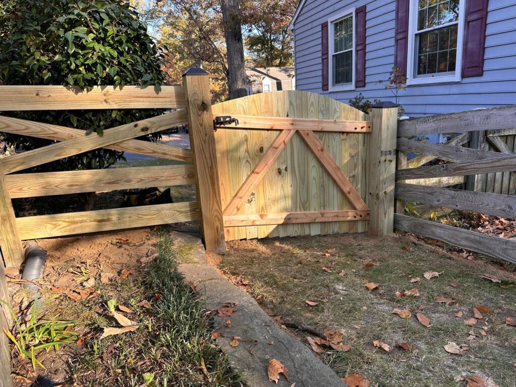 A rustic wooden split-rail style fence featuring a custom-built wooden gate, installed by AFK FENCE LLC in Waldorf, MD.