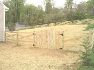 A newly installed wooden split rail fence with wire mesh and a matching wooden gate by A Freedom Fence in Martinsburg, WV.
