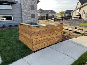 A custom-built wooden utility enclosure fence, demonstrating versatile fencing work by North CO Fence & Deck in Greeley, CO.