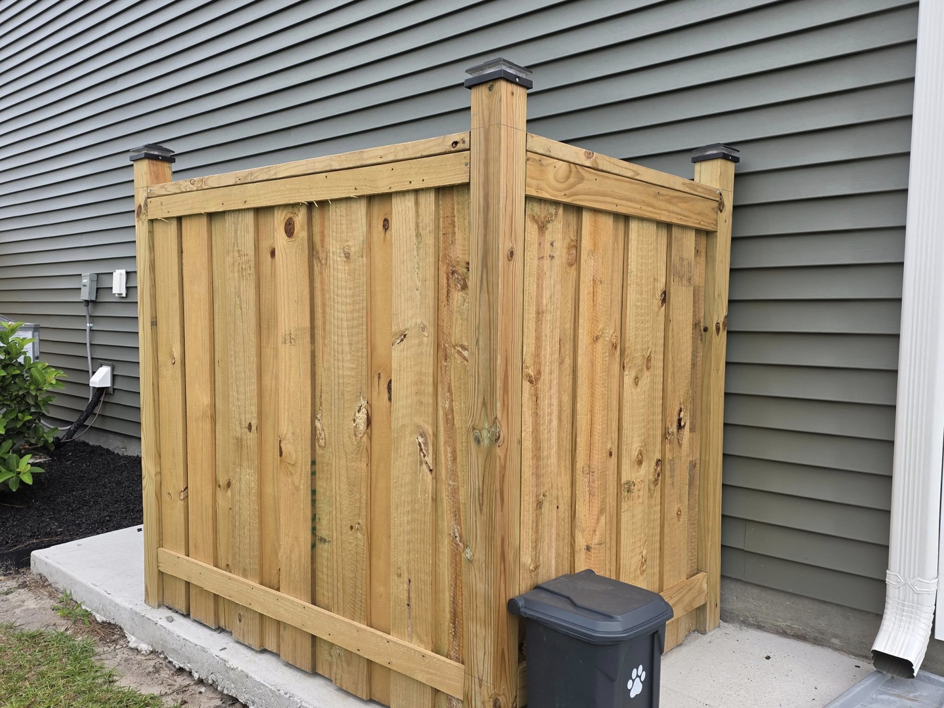 A custom wooden utility enclosure built by Montiel Fence Works in Wilmington, NC.