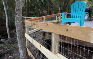A wooden fence with wire mesh installed as a railing or enclosure by Big Jerry's Fencing of Boise ID in Holly Springs, NC.