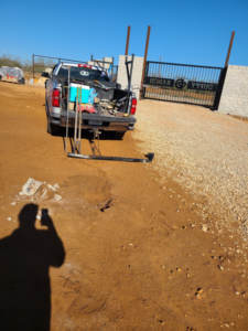 A work truck with tools parked in front of a large ranch gate during an installation by S.A. SAF-T Systems, LLC in San Antonio, TX.