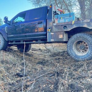 A heavy-duty work truck equipped with tools and equipment for fencing projects by Cool Hand Fencing and Wyo War Wagons in Laramie, WY.