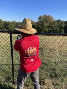 A fencing contractor from 985 Fence, LLC installing a black chain-link fence in Schriever, LA.