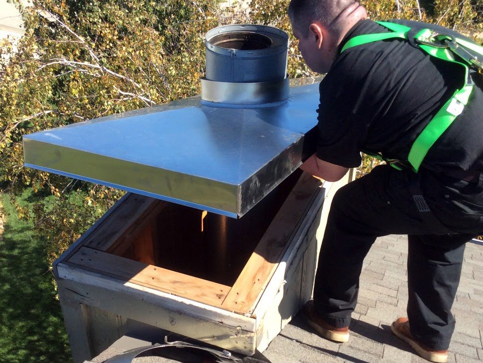 A worker installing a new chimney cap on a roof for Full Service Chimney in Overland Park, KS