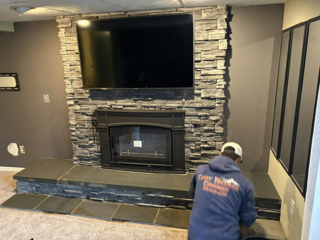 A Cozy Hearth Chimney technician installing a new fireplace insert in South Avington Township, PA.
