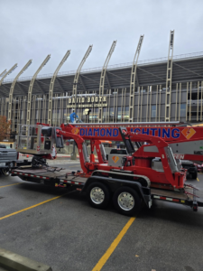 A worker from Diamond Lighting & Maintenance on a boom lift performing stadium lighting maintenance in Sheridan, IL.