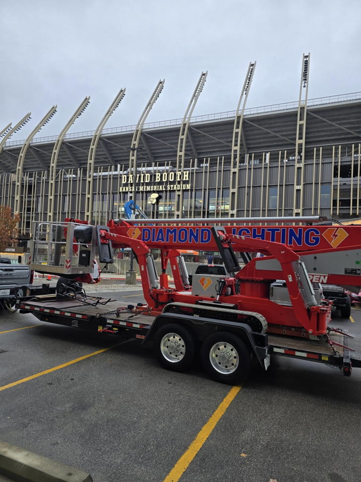 A worker from Diamond Lighting & Maintenance on a boom lift performing stadium lighting maintenance in Sheridan, IL.
