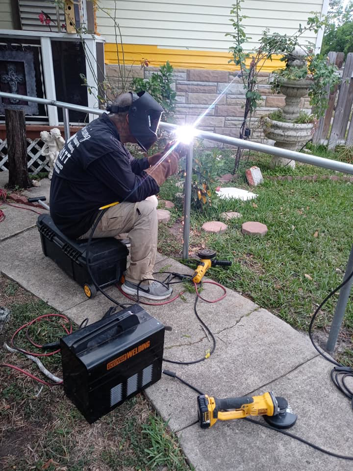 A worker welding a metal fence post during installation by Morin Fencing in Corpus Christi, TX.