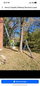 Two workers installing a flexible chimney liner, one on a ladder and one on the ground, by Harry's Quality Chimney Services in Kansas City, MO