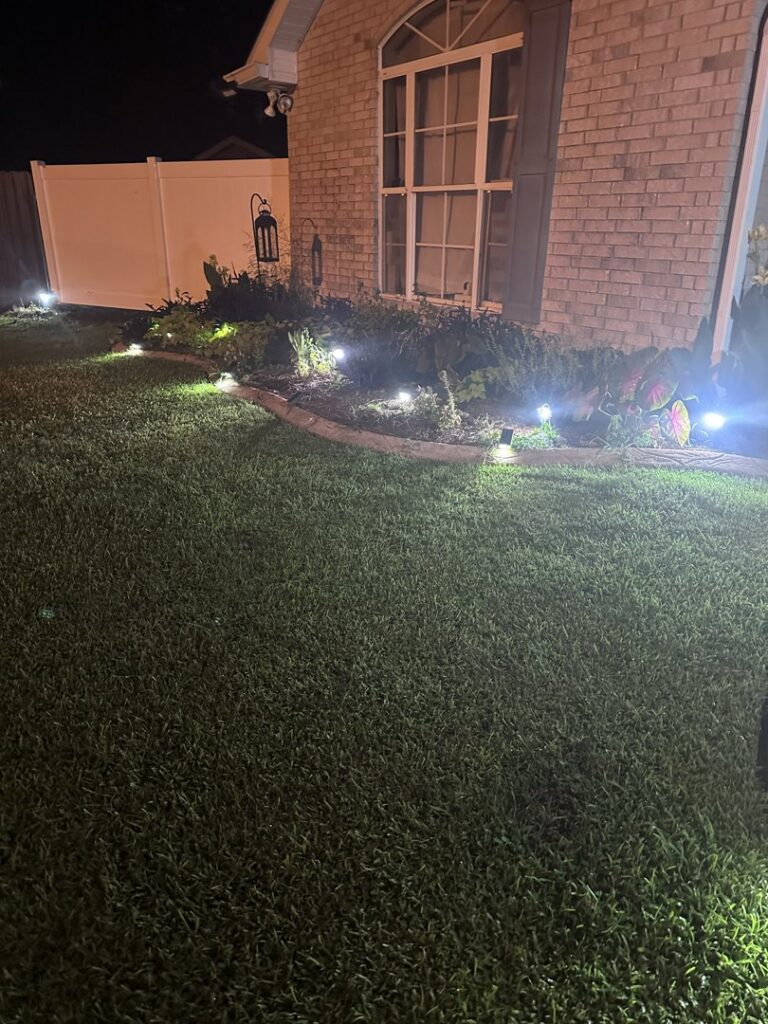 Workers installing a new white vinyl fence in a backyard for 5-Alarm Fence Company in New Orleans, LA.