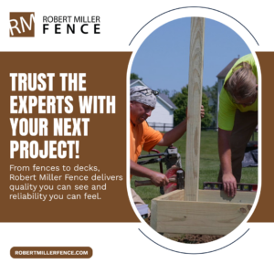 Two workers installing a new wood fence post with a level at Robert Miller Fence in Indianapolis, IN.