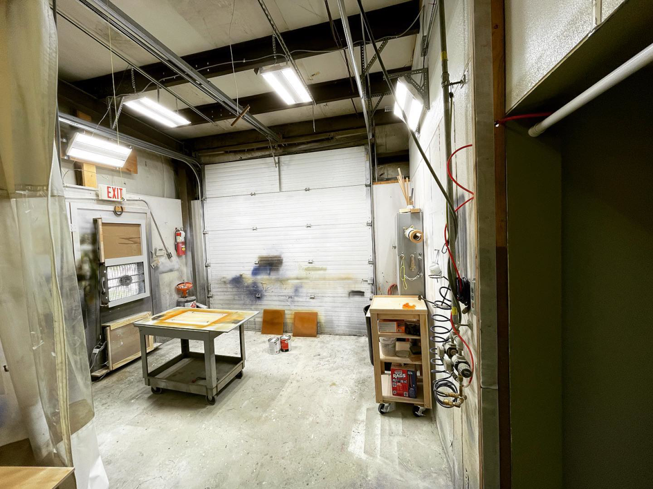 An industrial workshop with new lighting and electrical conduit installed by Southern Wind Electrical in West Des Moines, IA