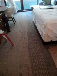 Worn carpet in a room, indicating a carpet removal or replacement job by New City Carpet And Flooring in Chicago, IL