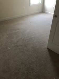 A room with worn carpet, likely before replacement or deep cleaning by S&H Floor Covering in Cross Junction, VA.