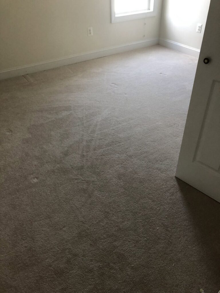 A room with worn carpet, likely before replacement or deep cleaning by S&H Floor Covering in Cross Junction, VA.