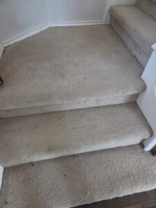 Worn and dirty carpeted stairs, ready for a deep clean by Master's Touch Steam Cleaning in San Antonio, TX.