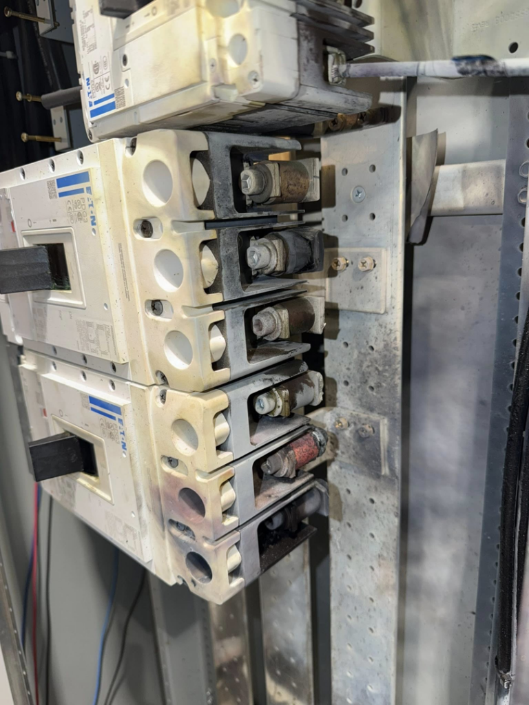 Worn circuit breakers inside an electrical panel, indicating a need for service from Power Tech Electrical Services in Durham, NC.