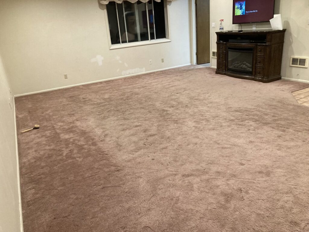 Worn residential carpet in a room, possibly before cleaning or repair by All Shine Cleaning Service in Idaho Falls, ID.