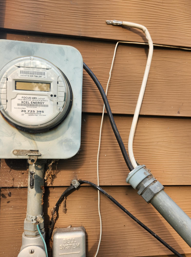 A close-up of an XCEL Energy electrical meter and wiring on a home by John Kivel Electric, LLC in Woodbury, MN.