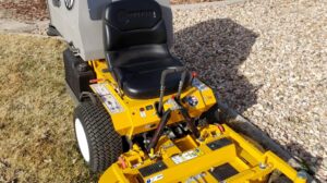 A yellow Walker riding lawn mower, a professional tool used by Aaron's Lawn Service in Pittsburg, KS.
