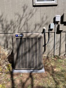 A newly installed York AC condenser unit outside a home by Pronto Air, an HVAC contractor in Olathe, KS.