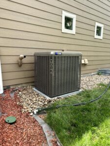 A York air conditioner condenser unit installed outside a home by Husky Heating and Cooling in Westminster, CO.